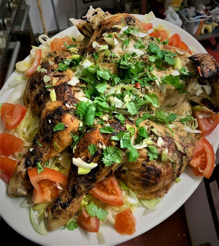 Grilled chicken topped with fresh herbs, served with lettuce and tomatoes